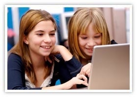Two pre-teen girls practicing online research in a class